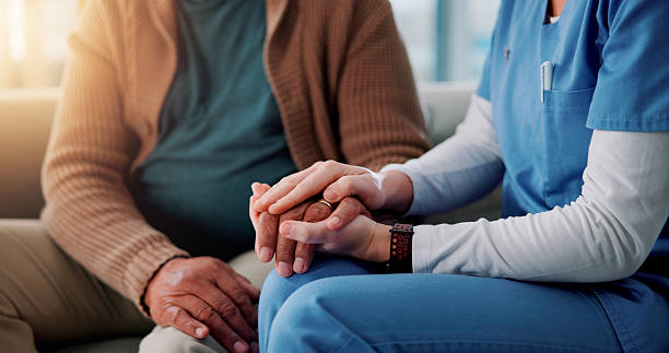 istock Home, caregiver and senior patient with holding hands for support, empathy and console after medical news. Sofa, nurse and old person with consultation for wellness, compassion and trust in closeup 2226435717
