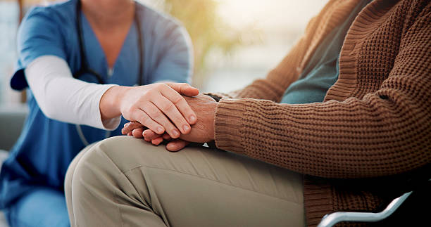 istock Couch, nurse and senior patient with holding hands for support, empathy and console for medical news. Home, caregiver and old person with consultation for wellness, compassion and trust in closeup 2226435775