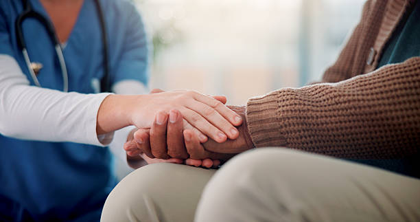 istock Empathy, nurse and senior patient with holding hands on sofa, support and console for medical news. Home, caregiver and old person with consultation for wellness, compassion and healthcare in closeup 2226435778
