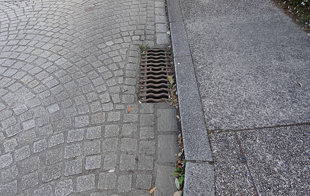 Paved street equipped with a rainwater drainage grid Urban environment