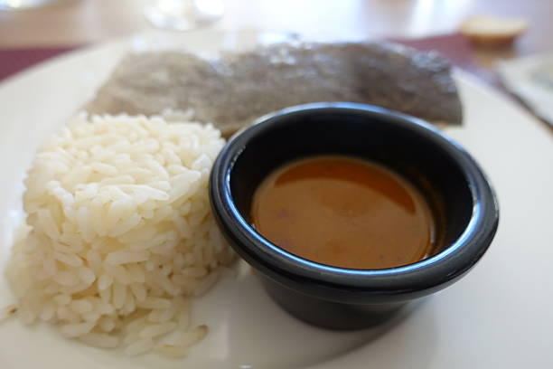 Pollack sea fish cooked served with  rice and a side sauce