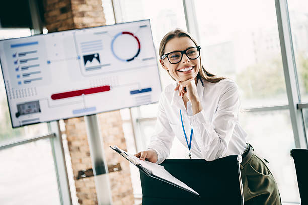 istock Charming young businesswoman analyzes data on a digital screen in a modern office with professional attire 2226436465