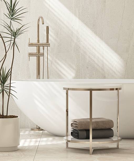 istock Minimal marble side table by white freestanding bathtub in modern, elegant bathroom, sunlight on stone tiled wall with tropical dracaena tree for luxury fashion, beauty, cosmetic, skincare, body care product display background 3D 2226438043