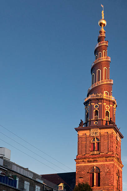 Vertical sunset view of the Vor Frelsers Kirke bell tower, Copenhagen