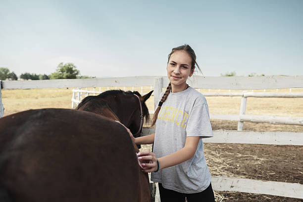 istock Young woman getting ready for a horse ride 2226440597
