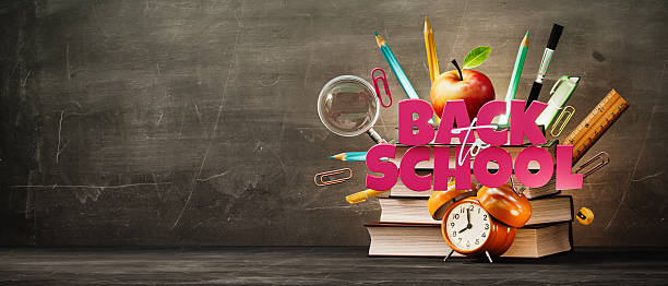 istock School accessories with books and Back To School text on blackboard background with copy space. 2226444839
