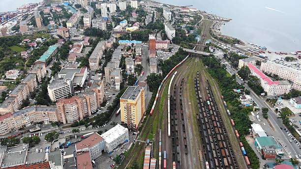 istock Aerial perspective capturing freight trains navigating coastal cityscape, moving cargo containers across urban transportation network 2226450861