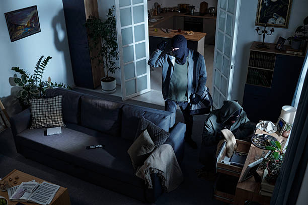istock Two Masked Men Stealing Valuables during Home Burglary at Night 2226451766