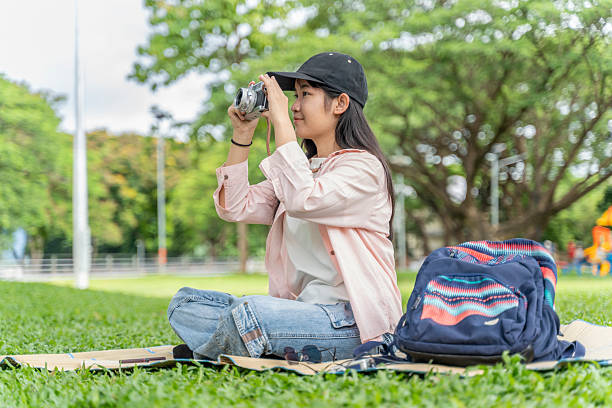 istock Young Woman with Retro Camera Outdoors 2226451836