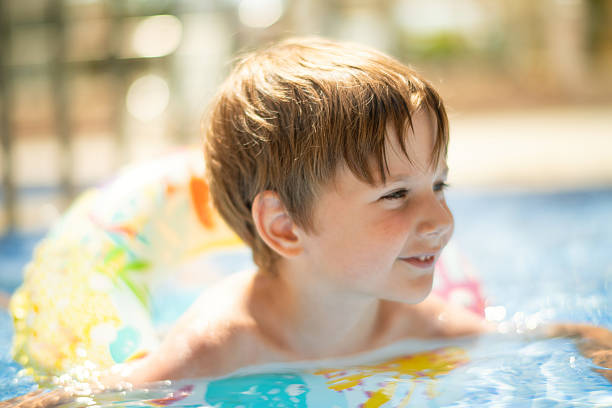 istock Happy boy swimming in a pool on summer holidays 2226453100