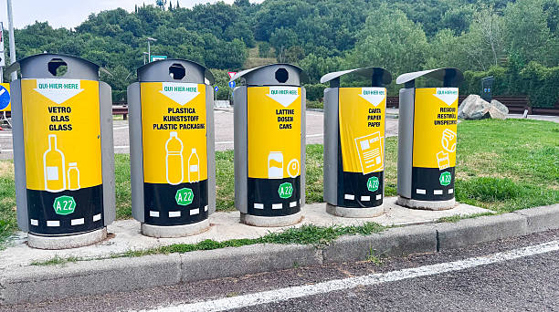 istock Public recycling bins for glass, plastic, paper and cans with labeled instructions, located roadside in a European town. Waste sorting initiative for environmental protection. 2226455075