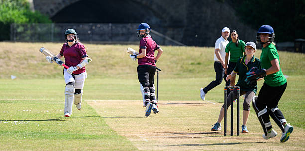 istock Batting team running between wickets watching ball with wicketkeeper and fielders ready to stump them out 2226458566
