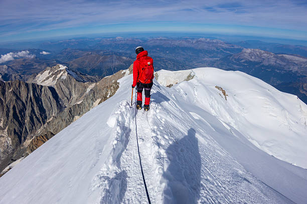 Chamonix, France - 8 August 2024: Climbers ascending Mont Blanc in daylight alpine landscape snowy mountain ridge outdoor adventure high altitude glacier mountaineering gear highest European peak scenery