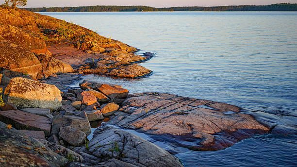 istock Rocky shore on a lake at sunset 2226459175