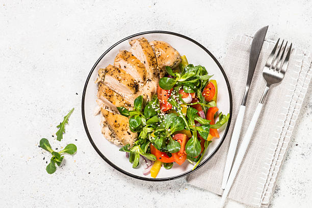 istock Baked chicken with fresh salad top view. 2226462676