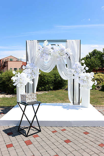 istock Beautiful white fabric arch decorated with white flowers. Wedding ceremony. 2226462810