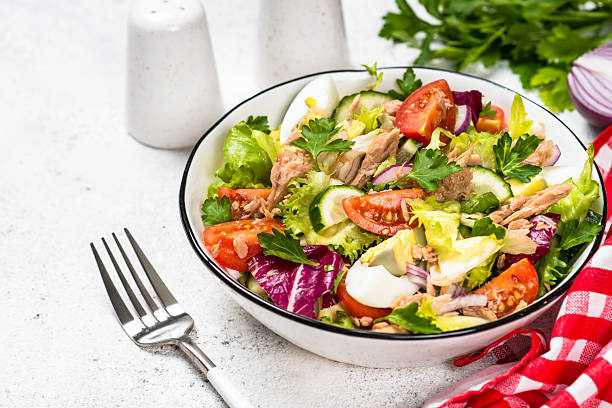 istock Tuna salad with green leaves, eggs and vegetables. 2226462938