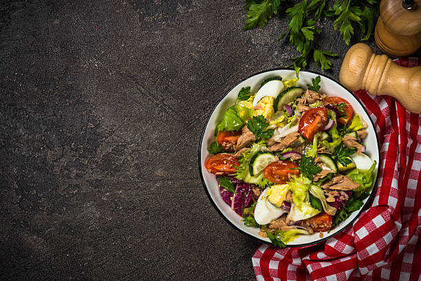 istock Tuna salad with green leaves, eggs and vegetables. 2226463761