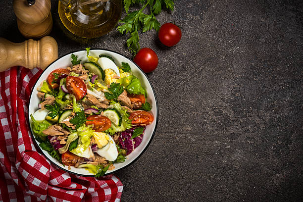 istock Tuna salad with green leaves, eggs and vegetables. 2226463762