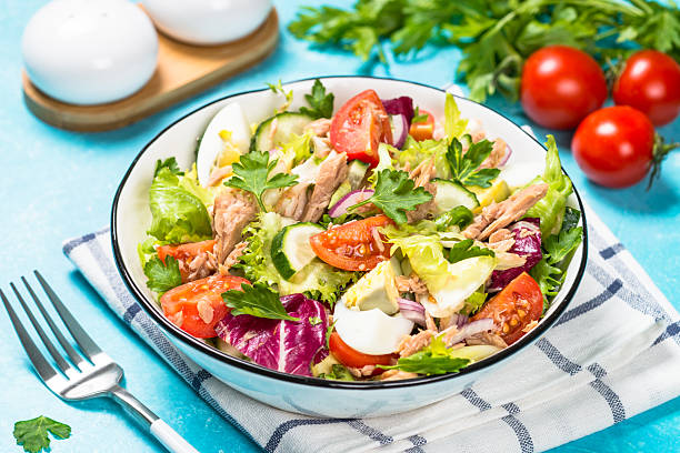 istock Tuna salad with green leaves, eggs and vegetables. 2226464049