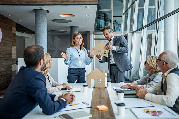 istock Business team analyzing architectural model of sustainable housing during meeting 2226467016
