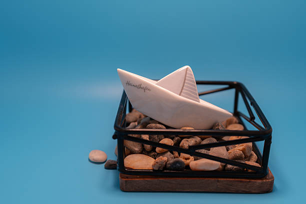 mini boat of stone decoration with blue background