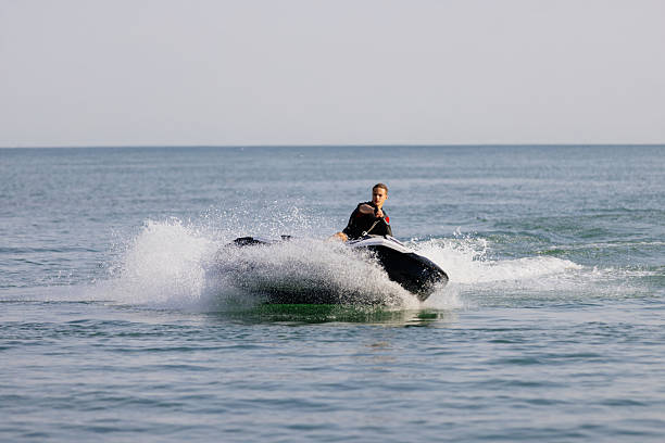 istock Young man rides a jet ski across turquoise waters during seaside vacation. 2226469314