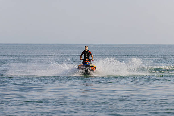 istock Young man speeds on a jet ski under the bright summer sun. 2226469378