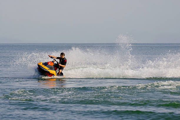 istock Young man rides a jet ski across turquoise waters during seaside vacation. 2226469389