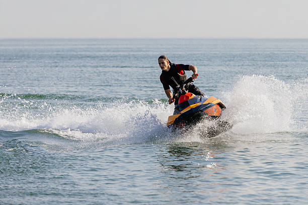 istock Young man rides a jet ski across turquoise waters during seaside vacation. 2226469391