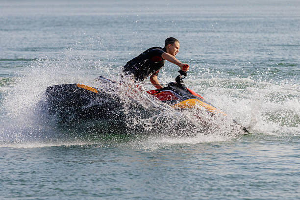 istock Young man speeds on a jet ski under the bright summer sun. 2226469397