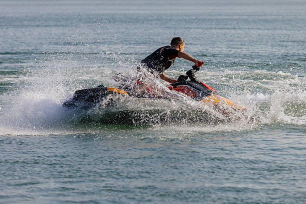 istock Man riding a jet ski across the water 2226469410