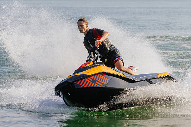 istock Young man enjoying a jet ski ride on the water. 2226469414