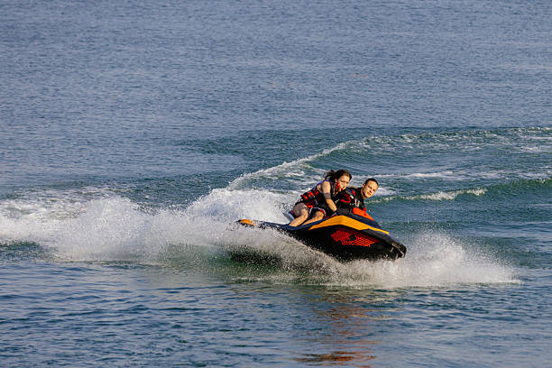 istock Happy couple riding a jet ski. 2226469455
