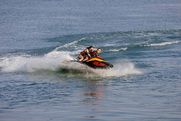 istock Happy couple riding a jet ski on water. 2226469461