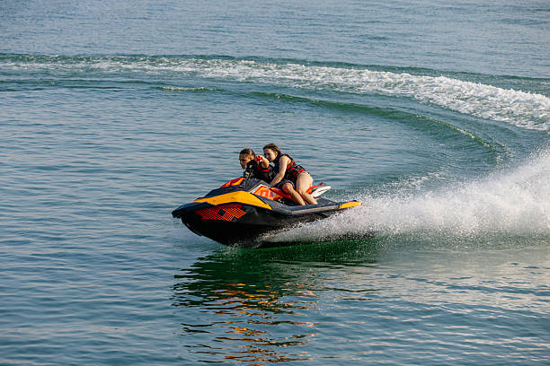 istock Happy couple riding a jet ski on water. 2226469509