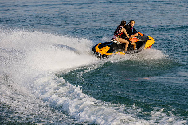 istock Happy couple riding a jet ski. 2226469513