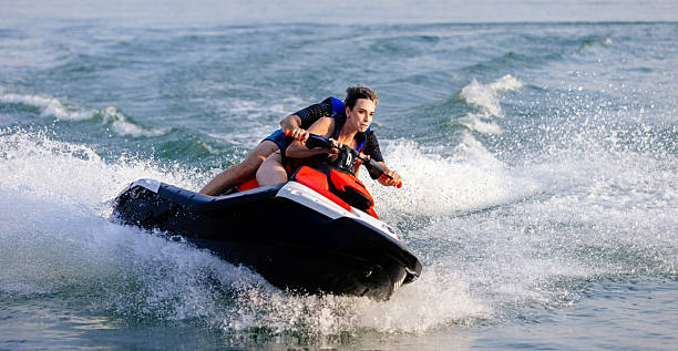 istock Happy couple riding a jet ski on water. 2226469531