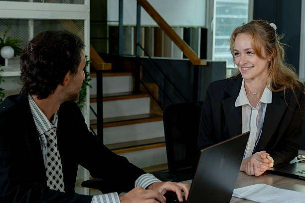 istock Caucasian female executive discussing work plan with male colleague using laptop during business meeting in modern office promoting teamwork collaboration and idea exchange between coworkers 2226470045