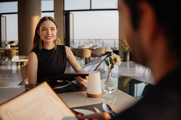 istock Elegant woman holding menu in a restaurant 2226471868