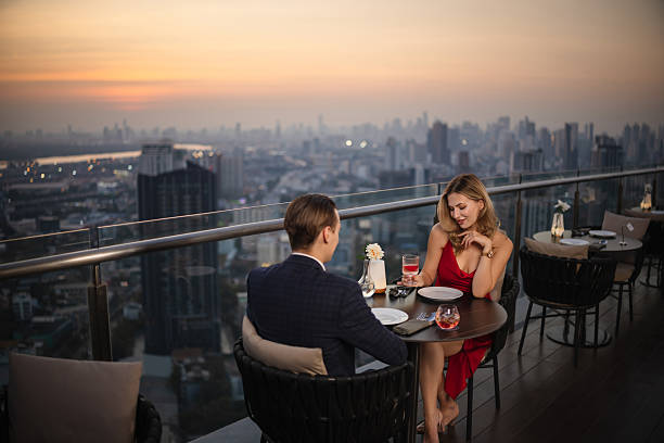 istock Couple enjoying drinks at a rooftop restaurant 2226472156