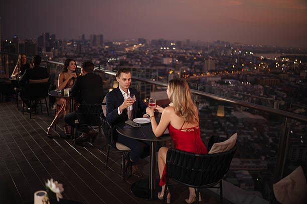 istock Couple enjoying drinks at a rooftop restaurant 2226472161