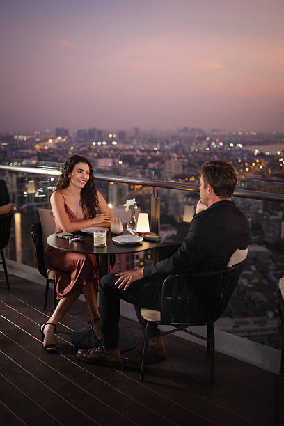 istock Couple enjoying drinks at a rooftop restaurant 2226472169