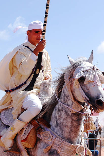 Brave and confident Moroccan berber horse rider preparing for  \