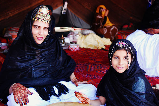 Berber sahrawi mother and daughter inside a jaima tent dressed with the \