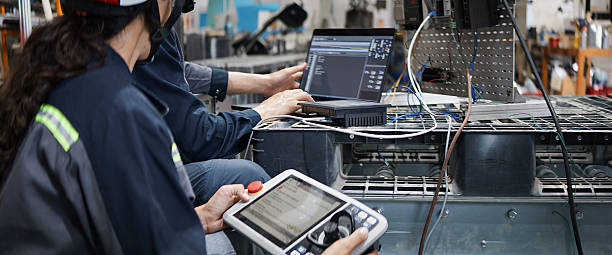 istock White industrial engineer man, woman work using laptop computer and tablet control electric machine in robotic factory. Mechanical industry engineering business. Blue collar worker, technology concept 2226476567