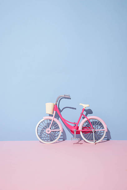 istock Bicycle with beige basket on a pastel pink and blue backround.Creative minimal concept 2226476926