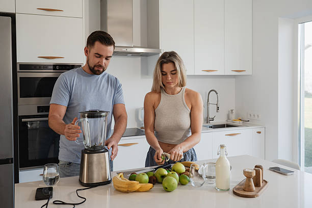 istock Couple Preparing Healthy Smoothie Together in Bright Modern Kitchen 2226479521