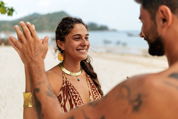 istock Playful couple dancing and laughing on beach 2226480041