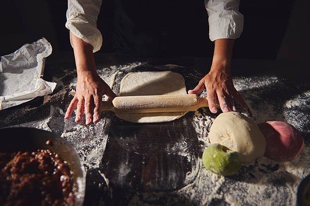 Close-Up Shot of Homemade Dough Preparation With Rolling Pin in Rustic Kitchen